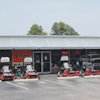 Clay uses the exterior of the store to showcase his larger outdoor power equipment. Financing and sale signs with font visible from the road entice passersby.