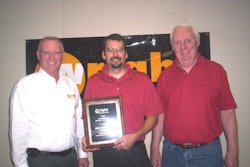 From left: Hal White, Wright vice president of sales and marketing, presents his company’s 2010 Distributor of the Year plaque to EDM vice president Joe McLean and vice president of sales Mike Flynn.