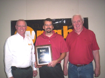 From left: Hal White, Wright vice president of sales and marketing, presents his company’s 2010 Distributor of the Year plaque to EDM vice president Joe McLean and vice president of sales Mike Flynn.