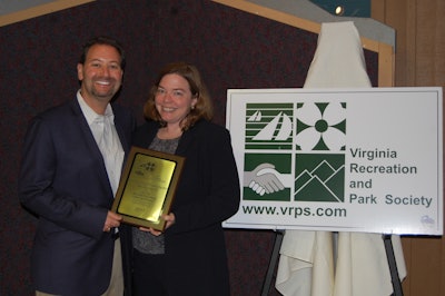 Virginia Parks and Recreation Director Michael Kalvort presents Anita Gambill, public relations specialist from Stihl Inc., with the VRPS Distinguished Private Sector Service Award.