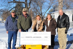 Roberta Jacobson (seated) and her husband Merlin (to her right) of Gordon, NE, are presented with a new Walker MBS mower. Bob Walker, president of Walker Manufacturing, was present for the surprise presentation. Jacobson received her demonstration in July from local Walker dealer Jay Hansen (far left) and his wife Phyllis.