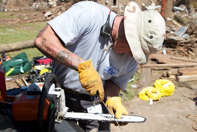 ROWW volunteer prepping a Stihl chainsaw for relief efforts.