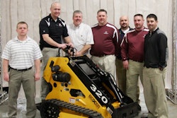 Jason Showers (at controls), Boxer product manager, was joined by Morbark's tree care sales team when the first Boxer loader rolled off the Morbark assembly line in March 2013.