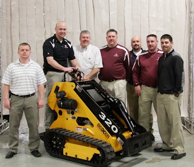 Jason Showers (at controls), Boxer product manager, was joined by Morbark's tree care sales team when the first Boxer loader rolled off the Morbark assembly line in March 2013.