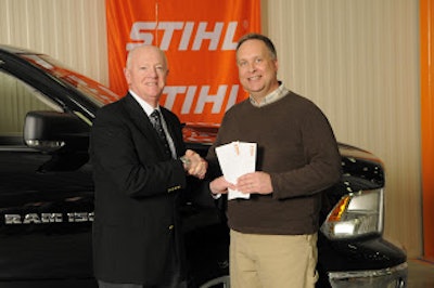 Marty Catron (right) accepts his plane tickets from Stihl Inc. president Fred Whyte (left).