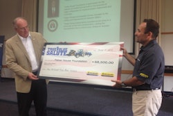 Abe Hughes, New Holland vice president of North America, presents the Fisher House Foundation with a check for $68,500.