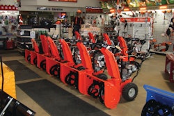 A dealership display of Ariens two-stage snowthrowers.