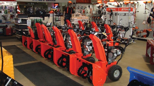 A dealership display of Ariens two-stage snowthrowers.