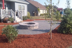 A completed paver patio with fire pit installed by Creekside Landscaping in Northwest Indiana.