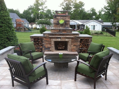 Outdoor living space with fireplace, designed and installed by Jonny Nichols Landscape Maintenance in Dover, DE.