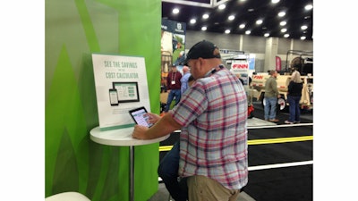 GIE+EXPO attendees try out the PERC cost calculator app in their booth at the show.