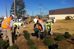YouthBuild students work with the Michael Hatcher & Associates install crew on a landscaping project at a health center.