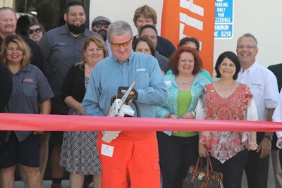 Larry Blamer, branch manager at Pacific Stihl, cuts the ribbon at the new facility with Stihl MSA 200 C-BQ Lithium-Ion battery-powered chainsaw.
