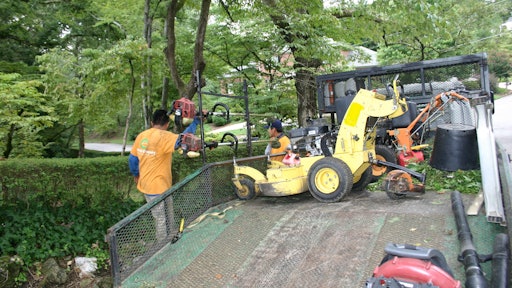 Landscape trailer setup with crew 5787e1a9f1663