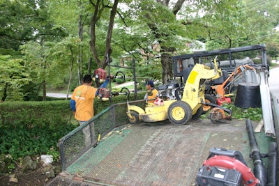 Landscape trailer setup with crew 5787e1a9f1663