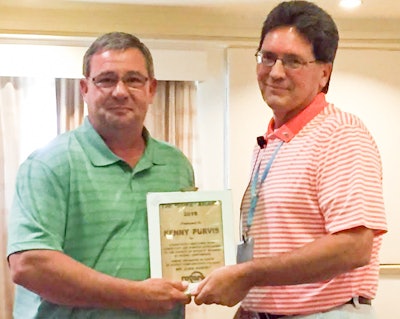 Mark Smith (striped shirt), Rotary’s vice president of sales and marketing, presents award to Kenny Purvis.