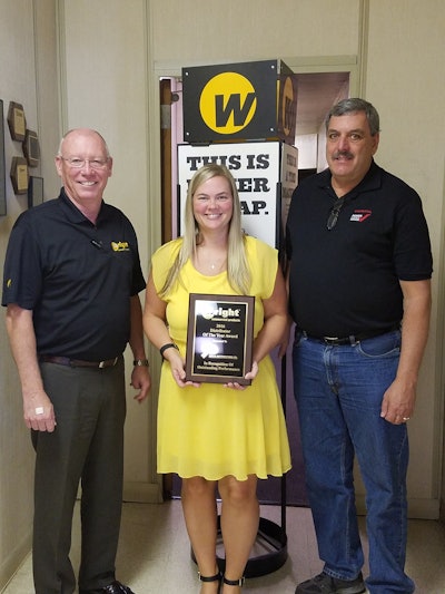 Hal White, Wright vice president of sales, presents the 2016 Distributor of the Year award to Smith Distributing general manager Kandis Caldwell and president Glenn Smith.