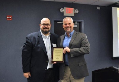 Roger Phelps (right), Stihl Inc. corporate communications manager, accepts a 2016 Channel Partnership Award from Dan Tratensek, NRHA vice president of publishing.