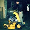 Bill Wright stands on his first Stander mower in 1997.