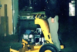 Bill Wright stands on his first Stander mower in 1997.