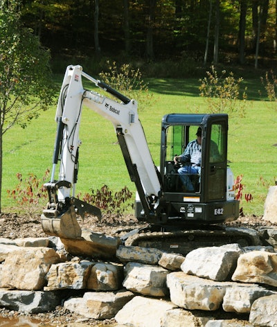 A Bobcat E42 compact excavator makes for easy work of a retaining wall.
