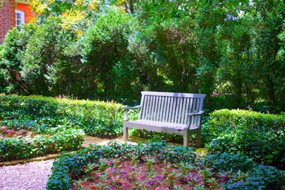 park bench in flower garden 5ae9e283b3771
