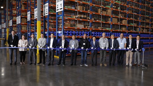 Doosan staff and dealers celebrate the new Doosan parts distribution center in Lacey, Wash. with a ribbon cutting.