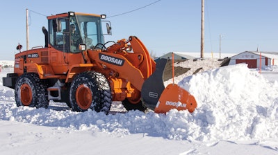 Make sure snow pusher attachments interfacing with a bucket are properly secured prior to use.