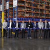 Doosan staff and dealers celebrate the new Doosan parts distribution center in Lacey, Wash. with a ribbon cutting.