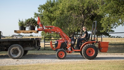 Kubota’s B2301 compact tractor, with its roughly 1,400-pound lifting capacity and optional pallet fork attachment, can efficiently load a variety of common landscaping materials into trucks.