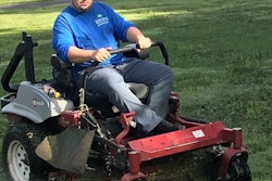 Christian Brown takes care of lawn on an Exmark mower.