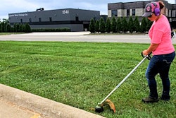 Savanaha Spencer (AKA 'TQ' or 'Trimming Queen') of Spencer Lawn Care doing trim work.