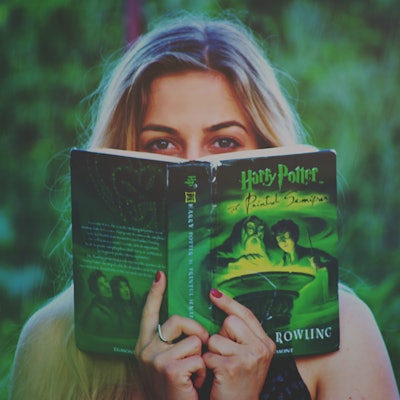 Woman Reading Harry Potter Book 1314584