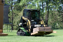 A small sit-in compact track loader moves a loaded pallet across a lawn. Small residential or backyard projects don’t necessarily need a huge machine.