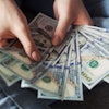 Person Holding 100 Us Dollar Banknotes 2068975