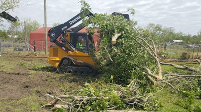Daniel Smith operating his skid steer to help with debris removal. “Many people came together to help others - folks they did not even know. It was a special show of love for families who have lost so much,” David Smith concluded.