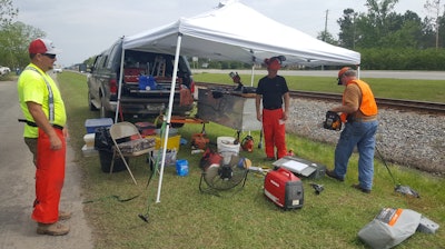 A “mini saw shop” was setup underneath this tent for maintenance and repairs. Altogether, five volunteers worked on the Rotary team during the two-day cleanup.