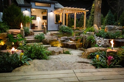 Decker’s Pondscapes’ infinity edge pond and sunken patio fire pit display.