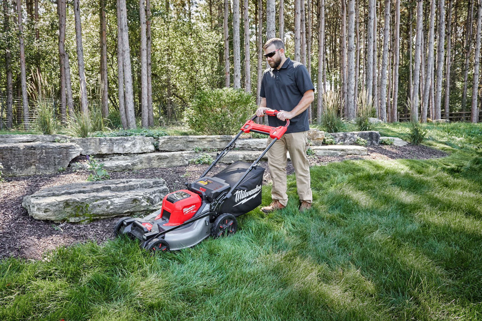 Image of Group of people mowing lawn with Milwaukee M18 battery operated lawn mowers