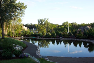 'Allison Arscott used a variety of plants, created specialty gardens and designed pathways and plantings that allowed our client to enjoy their stroll to the office as much as their walk around the pond,' Rose says.