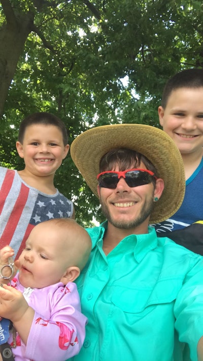 Darren Johnson, owner of Long Term Lawn Care, with his three children.