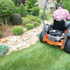 A mower operator practicing safe power equipment guidelines while he works.