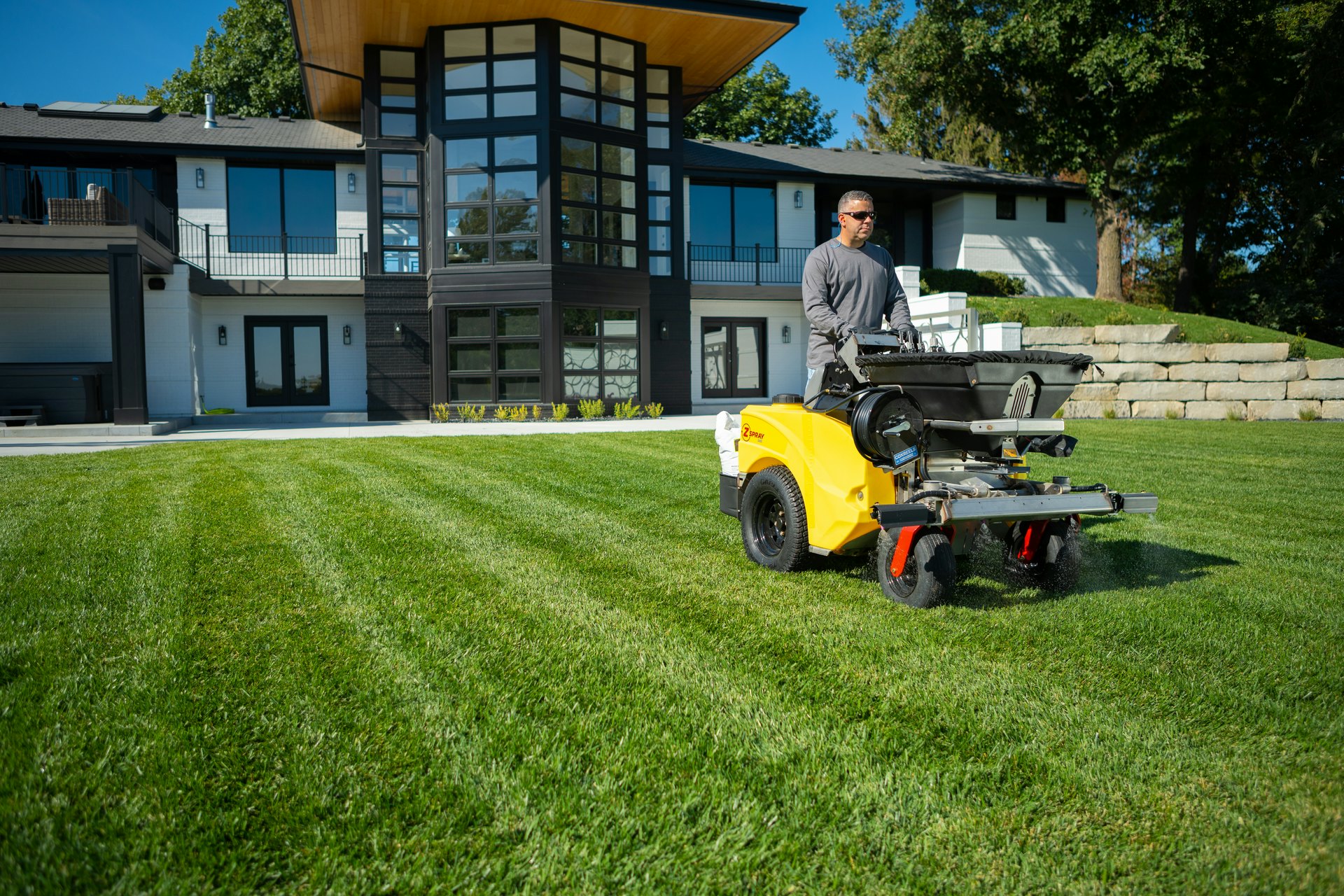 Stand-on spreader-sprayers allow lawn care operators to do more with less.