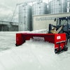 A pusher plow pushing snow.