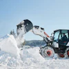 Bucket attachments can be added to compact equipment to help contractors perform snow and ice management services.