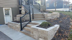 This project involved Overall, the project involved incorporating natural stone retaining walls, bluestone paving and a revamped deck.