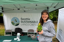 Nicolette McCary works the Seattle Sustainable Landscapes booth at the Tilth Alliance Edible Plant Show in May 2024.