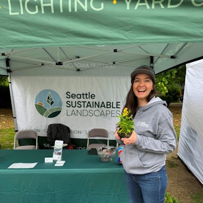 Nicolette McCary works the Seattle Sustainable Landscapes booth at the Tilth Alliance Edible Plant Show in May 2024.