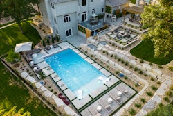 Complete with a pool, fire pit, outdoor kitchen and covered pergola dining area, this client's yard has been transformed into an outdoor oasis.