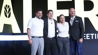 Brian Weisbaum (second from left) poses at the 2025 New Holland Construction National Dealer Meeting.